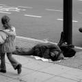 Canadian man resting on sidewalk