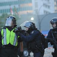 Image: "VPD anti-riot officers" by Charles de Jesus . Licensed under CC BY 2.0 v