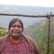 A CEIBA promoter in Santiago, Guatemala with valley behind her.