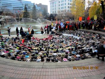 1500 pairs of women's and children's shoes arranged in a huge circle